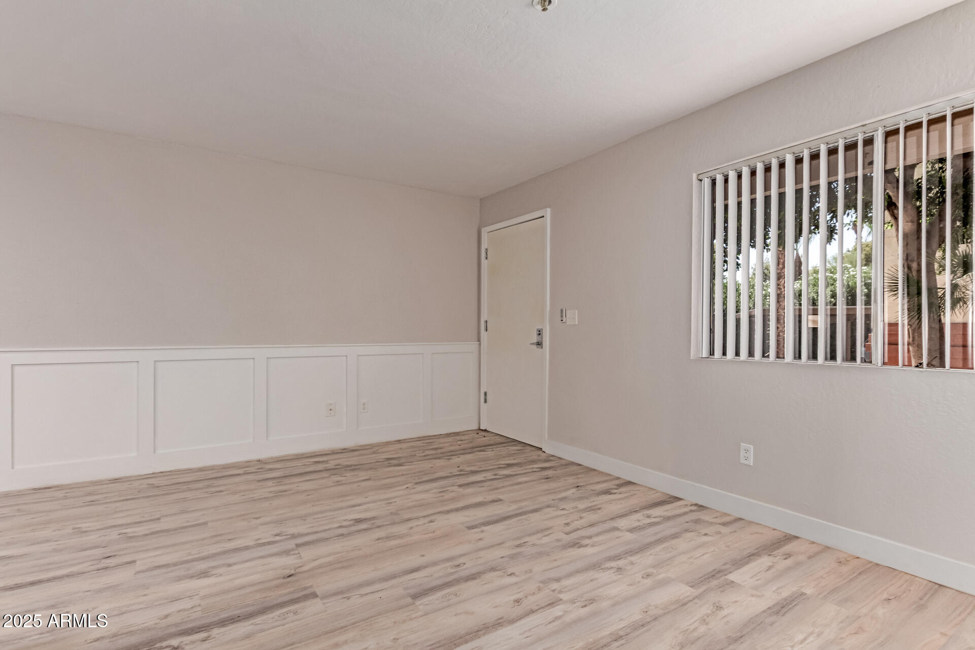 12123 West Bell Road, Unit 138 Surprise, AZ 85378 - Photo 12 of 28 a view of an empty room with wooden floor