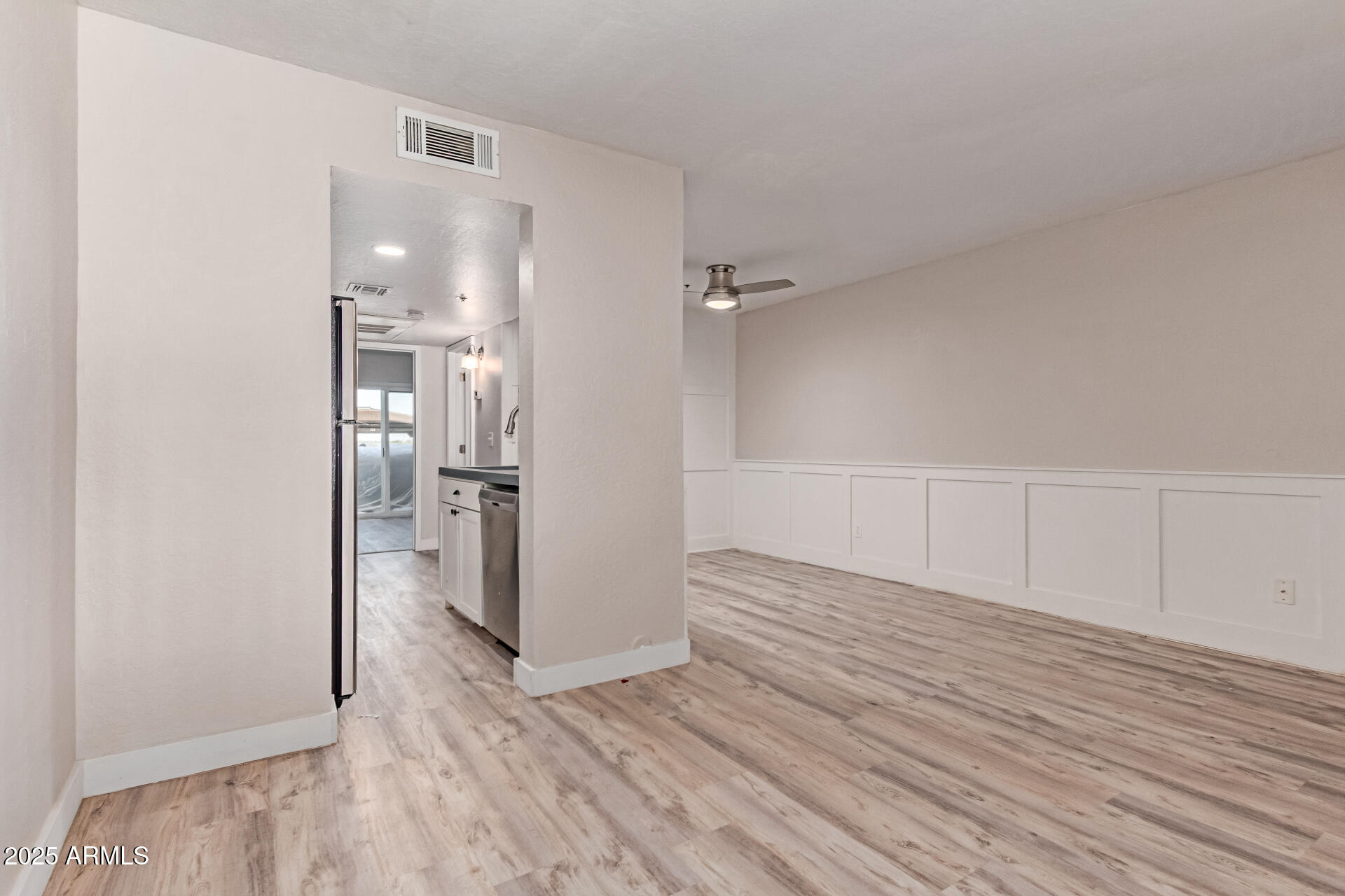 12123 West Bell Road, Unit 138 Surprise, AZ 85378 - Photo 13 of 28 a view of empty room with wooden floor