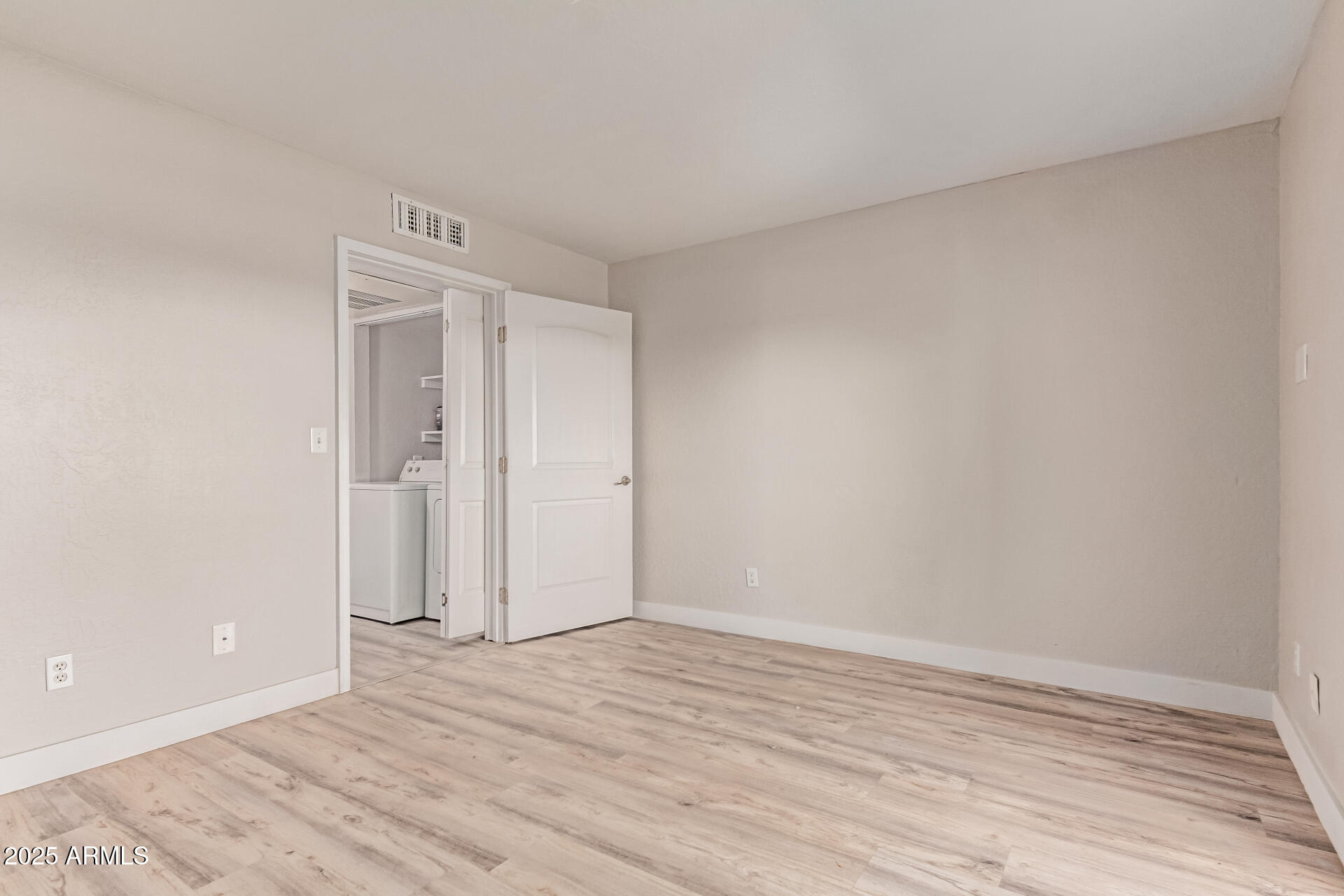 12123 West Bell Road, Unit 138 Surprise, AZ 85378 - Photo 19 of 28 a view of an empty room and wooden floor