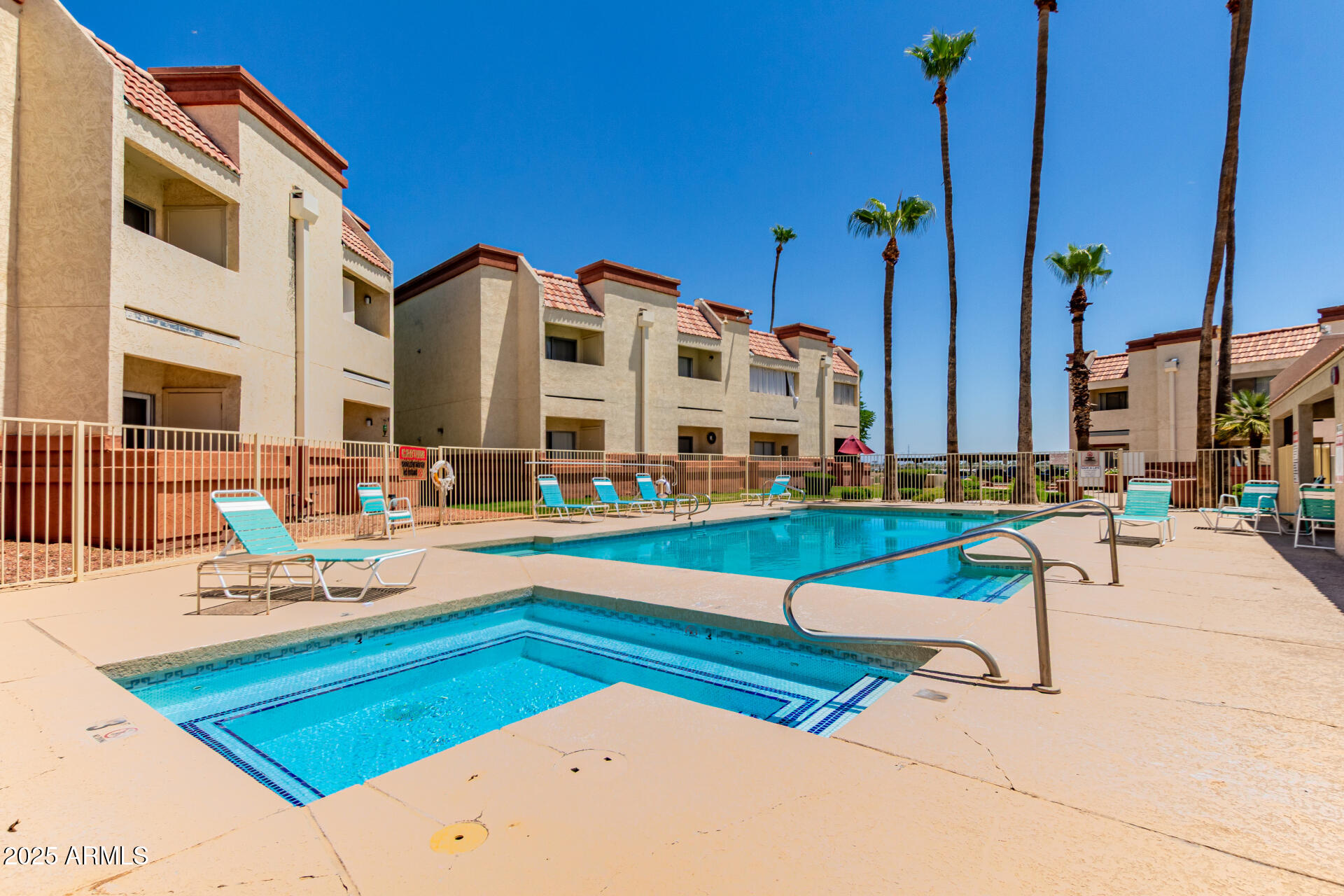 12123 West Bell Road, Unit 138 Surprise, AZ 85378 - Photo 24 of 28 a view of a patio with a table and chairs