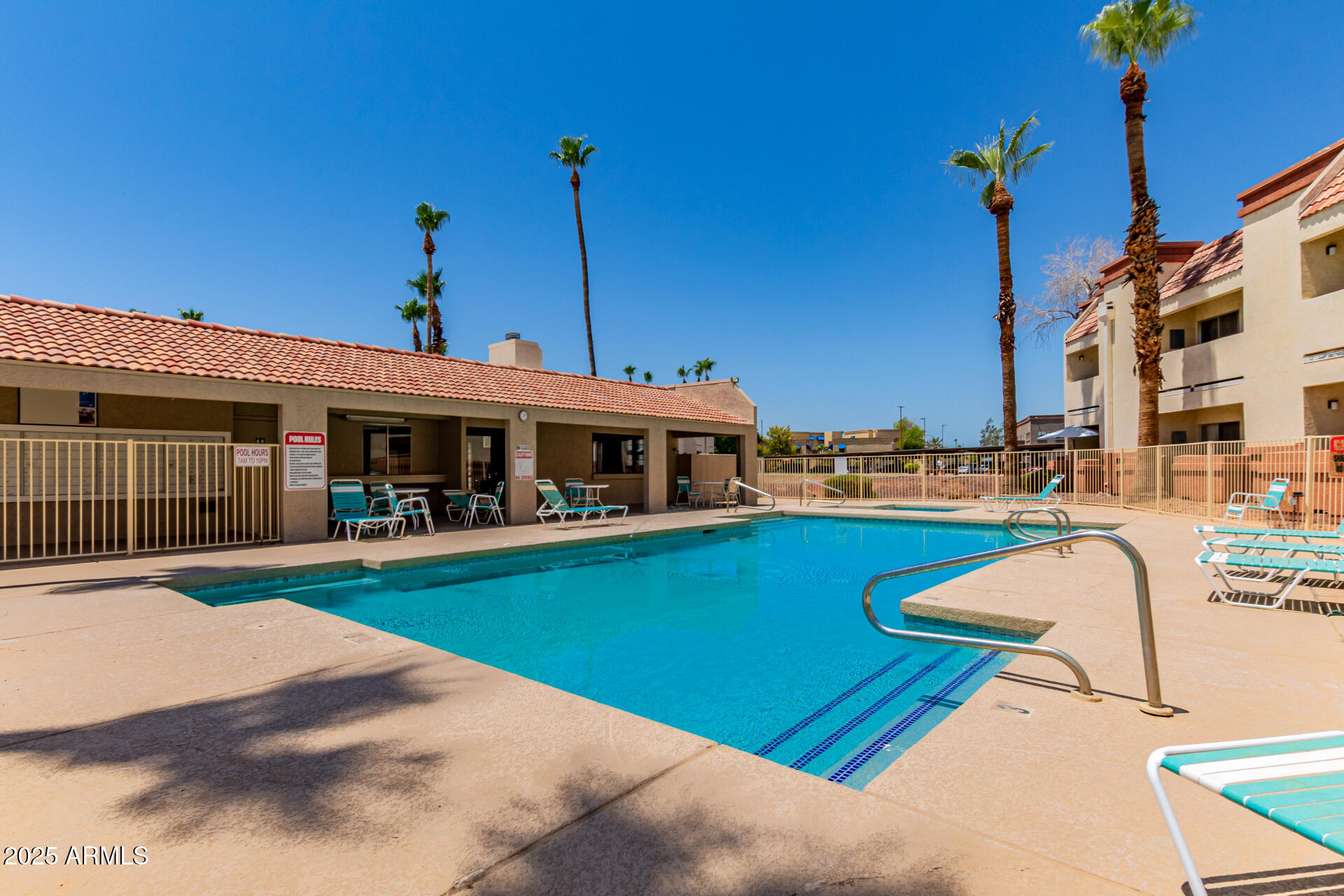 12123 West Bell Road, Unit 138 Surprise, AZ 85378 - Photo 25 of 28 a front view of a house with swimming pool