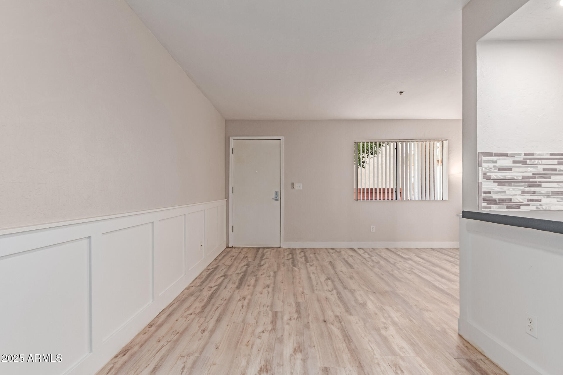 12123 West Bell Road, Unit 138 Surprise, AZ 85378 - Photo 9 of 28 wooden floor in an empty room with a window
