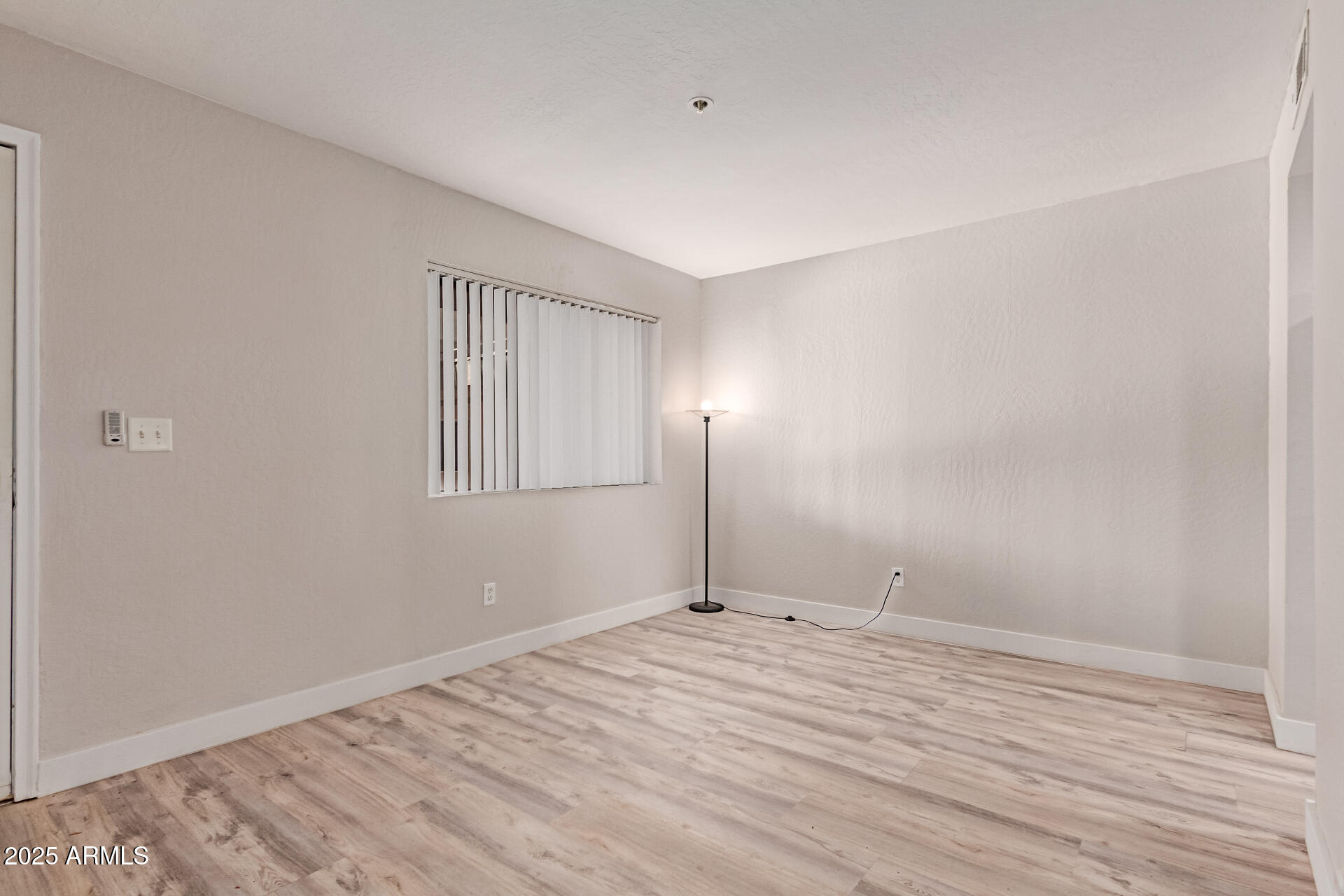 12123 West Bell Road, Unit 138 Surprise, AZ 85378 - Photo 10 of 28 a view of empty room with wooden floor