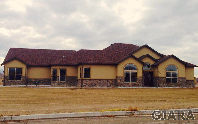 775 Foxtail Road Grand Junction, CO 81505 - Photo 1 of 1 a front view of a house with yard and ocean view