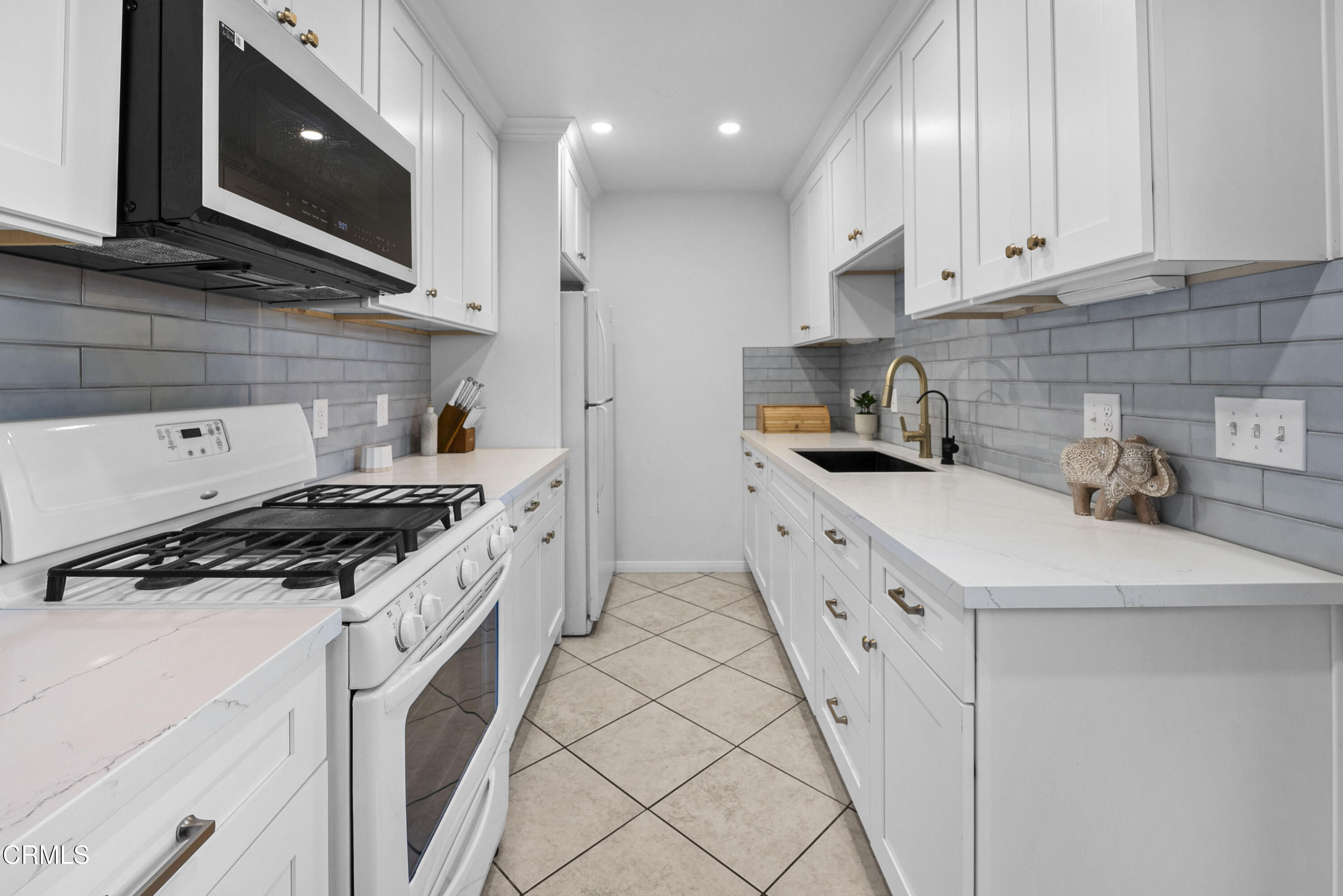 1012 Cheyenne Way Oxnard, CA 93033 - Photo 7 of 16 a kitchen with granite countertop a sink a stove and cabinets