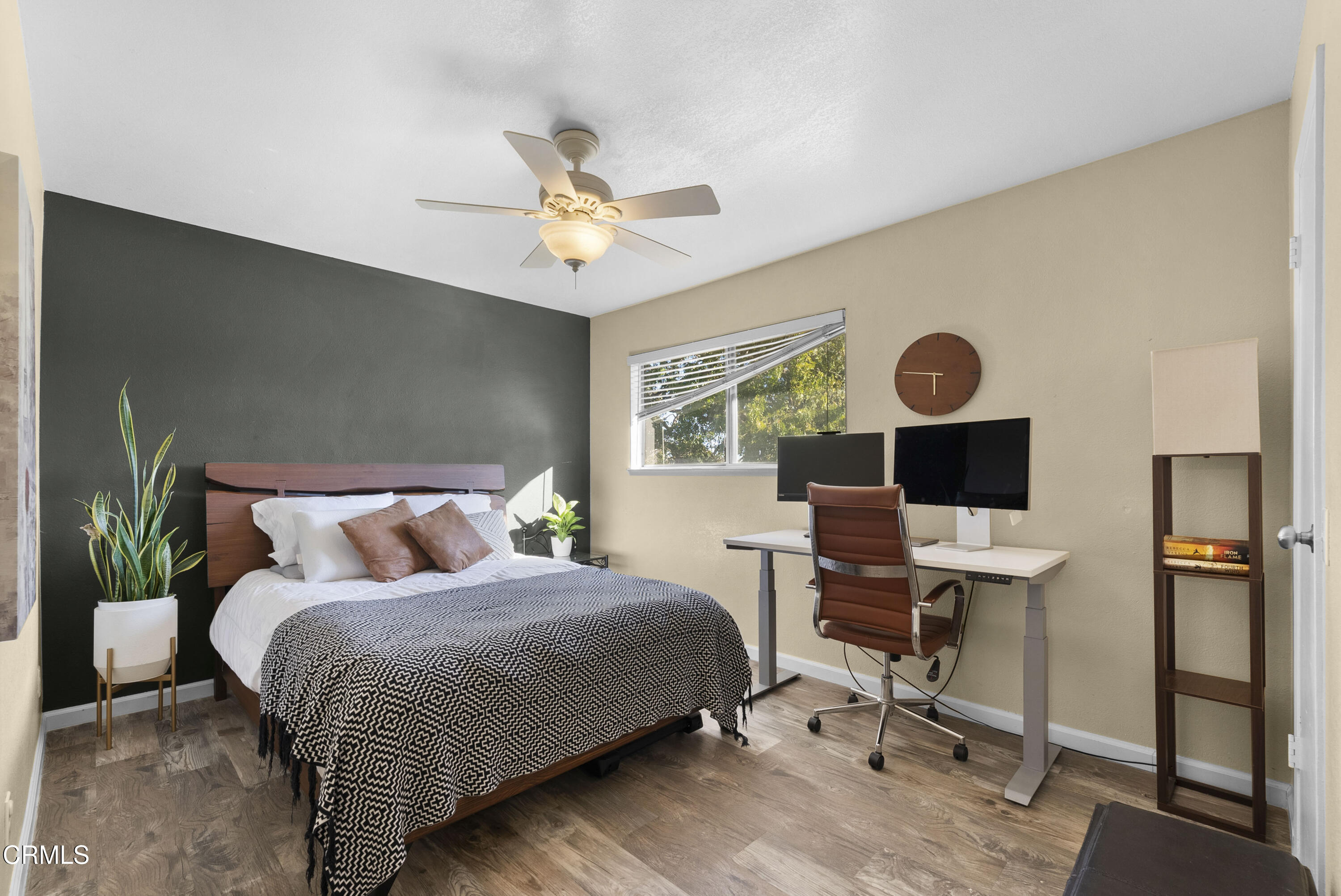 1012 Cheyenne Way Oxnard, CA 93033 - Photo 9 of 16 a bedroom with a bed a desk and chair with wooden floor