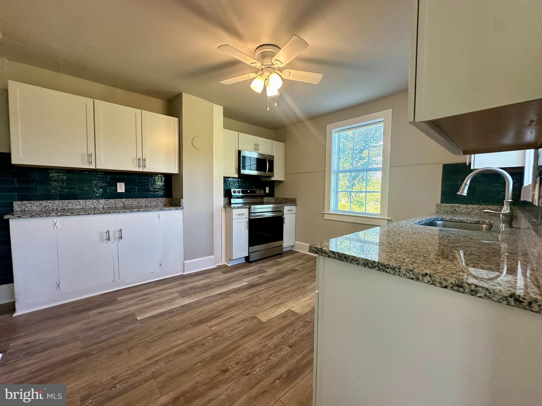 16142 Brandy Road Culpeper, VA 22701 - Photo 3 of 21 a kitchen with granite countertop a sink stainless steel appliances and cabinets