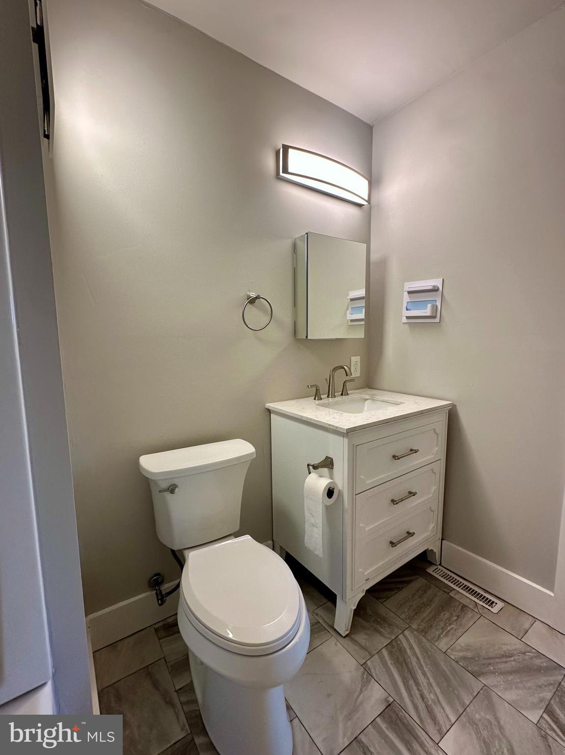 16142 Brandy Road Culpeper, VA 22701 - Photo 9 of 21 a bathroom with a toilet sink and mirror