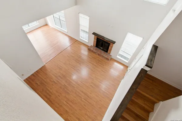 a view of an empty room and wooden floor
