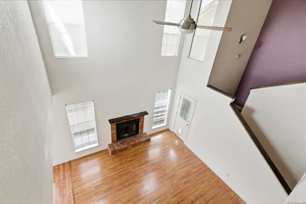 a view of a livingroom with wooden floor and staircase