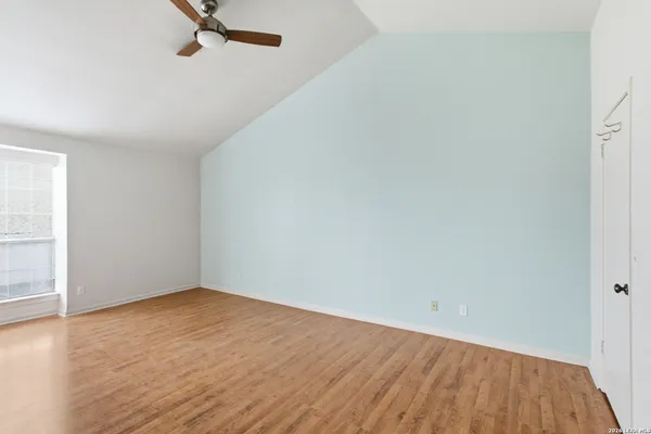 a view of a room with wooden floor
