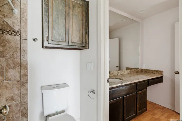 a bathroom with a granite countertop sink and a mirror