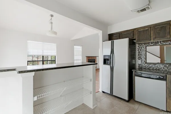 a kitchen with stainless steel appliances a refrigerator and a stove top oven
