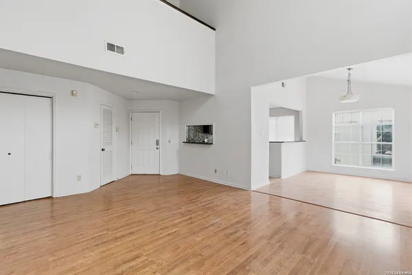 a view of empty room with wooden floor and cabinet