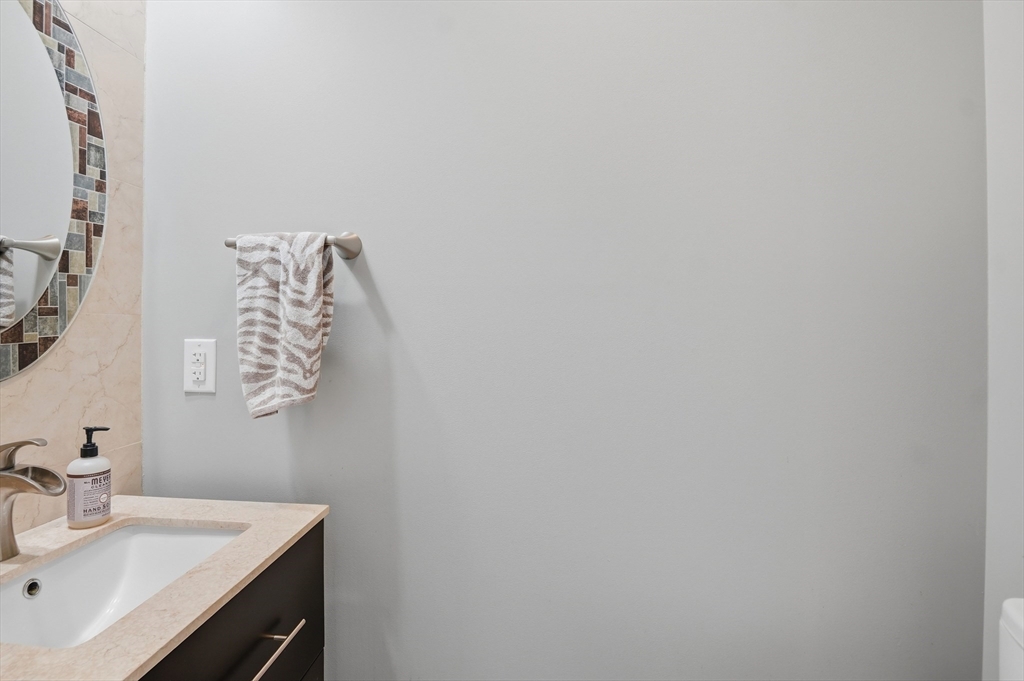 112 Pineland Avenue Worcester, MA 01604 - Photo 29 of 38 a bathroom with a sink and vanity