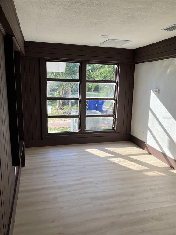 11630 79th Avenue Seminole, FL 33772 - Photo 12 of 14 a view of empty room with wooden floor and fan