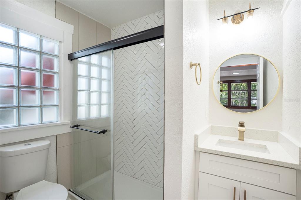 11630 79th Avenue Seminole, FL 33772 - Photo 5 of 14 a bathroom with a toilet sink and mirror