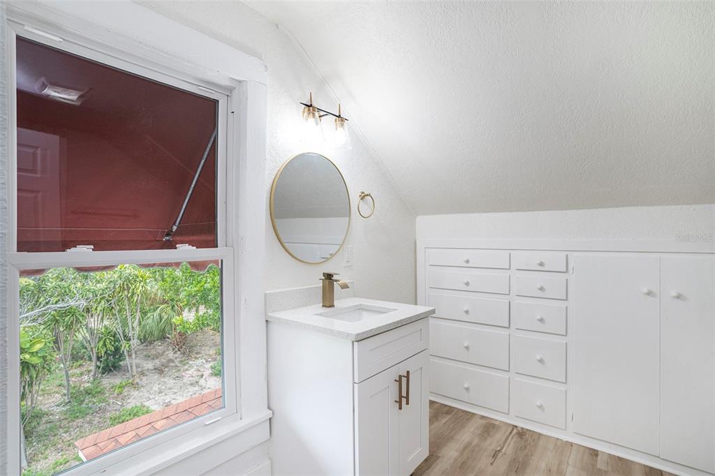 11630 79th Avenue Seminole, FL 33772 - Photo 7 of 14 a bathroom with a sink and a mirror