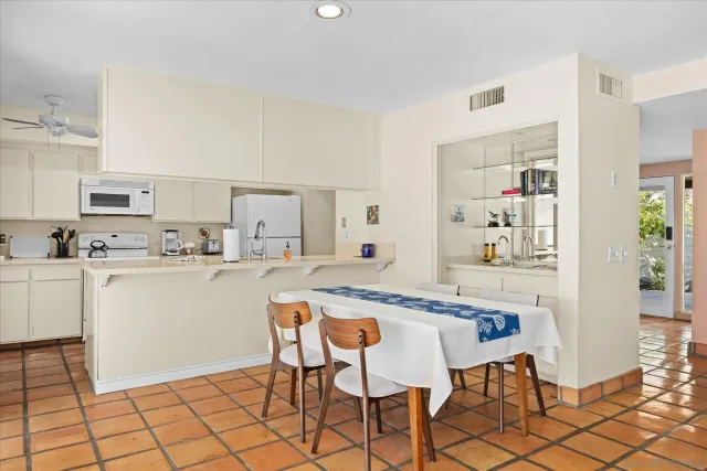 a swimming pool with outdoor seating and yard