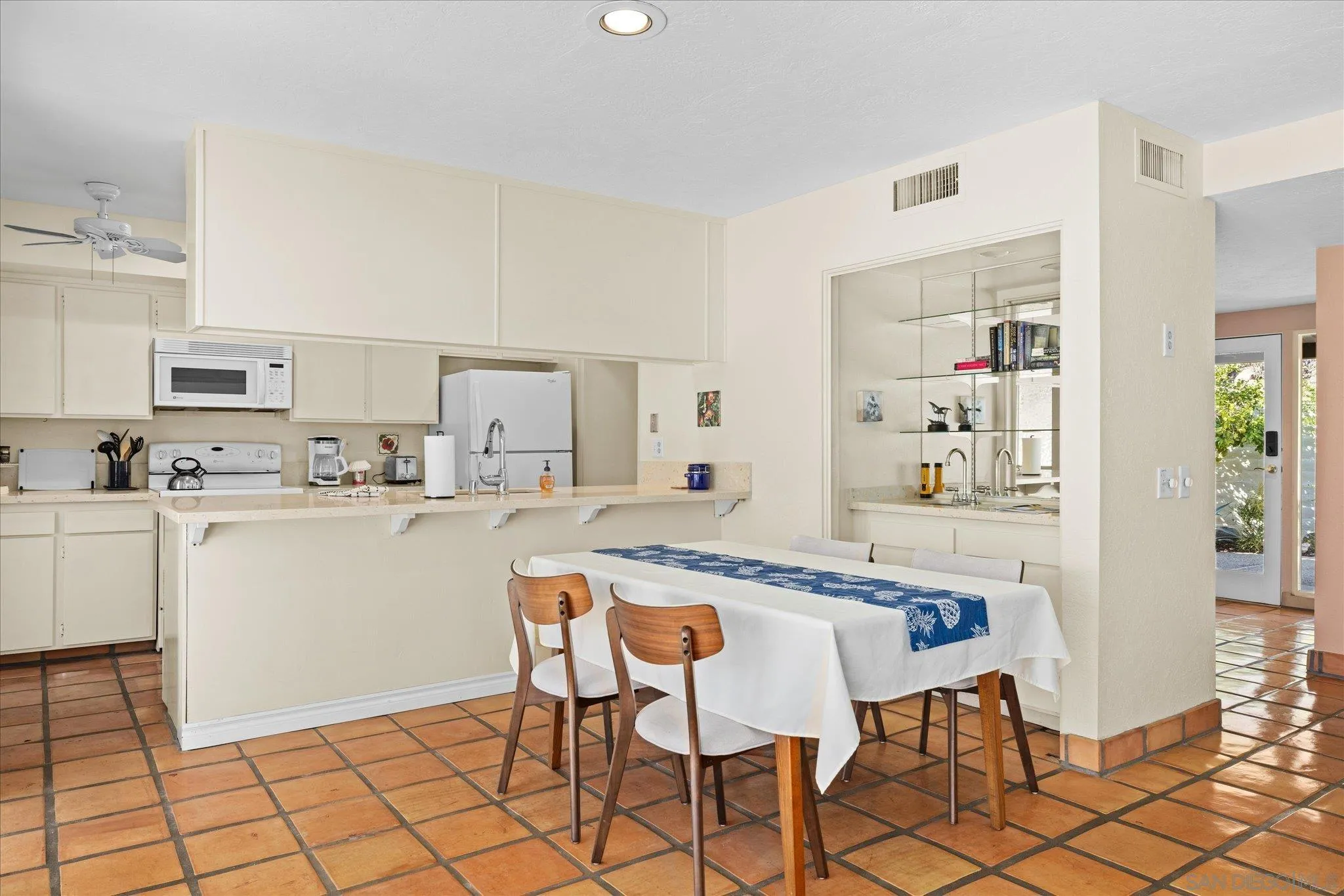 1668 Montezuma Court, Unit 22 Borrego Springs, CA 92004 - Photo 21 of 75 a kitchen with white cabinets and appliances