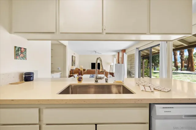 a view of a swimming pool with a patio and a garden