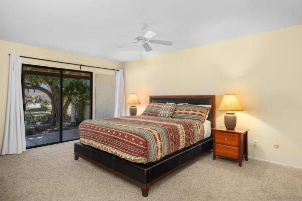 a spacious bedroom with a bed and large window