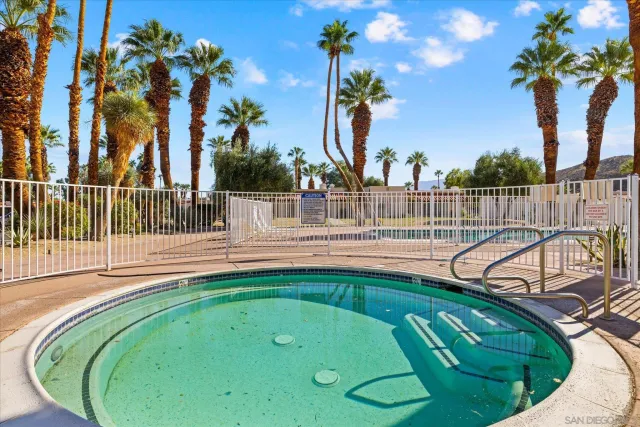an aerial view of residential houses with outdoor space and mountain view