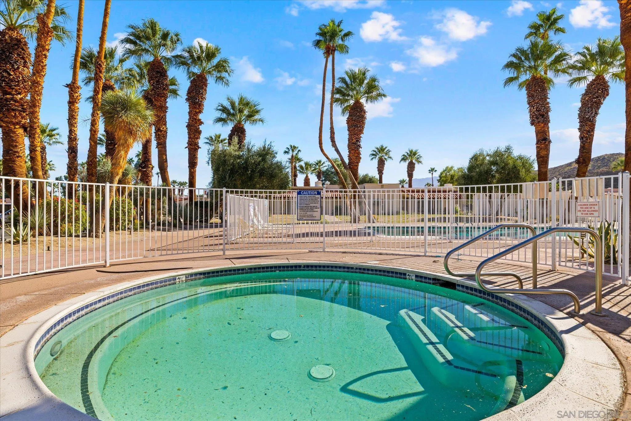 1668 Montezuma Court, Unit 22 Borrego Springs, CA 92004 - Photo 33 of 75 a view of a swimming pool with a patio and a garden