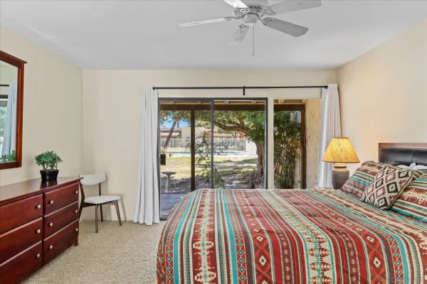 a bedroom with a bed and a large window