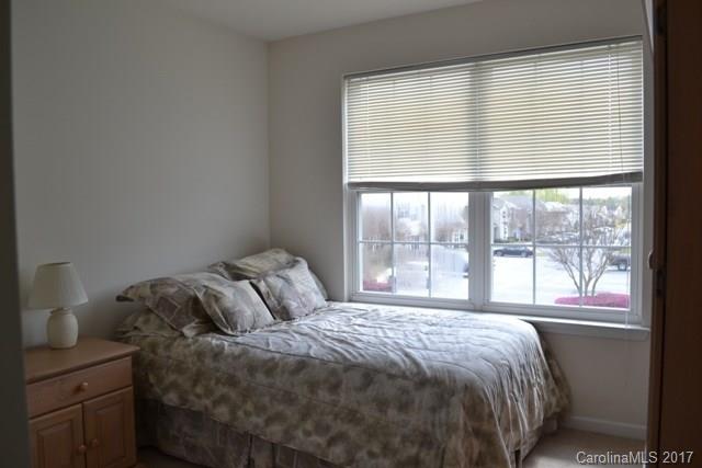 310 Tinder Box Lane, Unit 310 Fort Mill, SC 29708 - Photo 12 of 19 a bedroom with a bed and a large window
