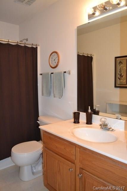 310 Tinder Box Lane, Unit 310 Fort Mill, SC 29708 - Photo 13 of 19 a bathroom with a granite countertop toilet sink and mirror