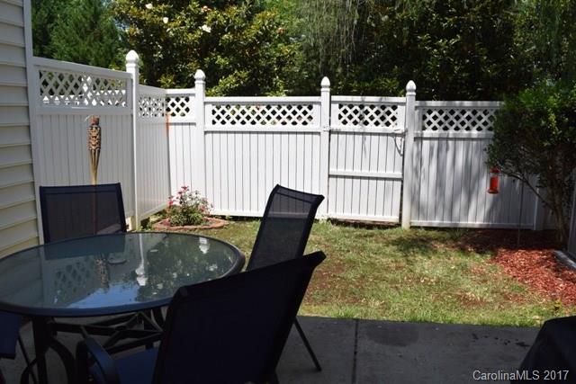310 Tinder Box Lane, Unit 310 Fort Mill, SC 29708 - Photo 14 of 19 a backyard of a house with table and chairs