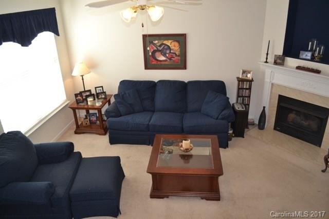 310 Tinder Box Lane, Unit 310 Fort Mill, SC 29708 - Photo 4 of 19 a living room with furniture a fireplace and a flat screen tv