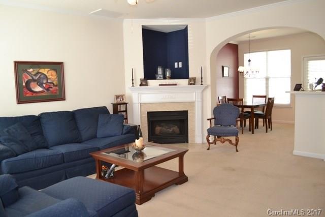310 Tinder Box Lane, Unit 310 Fort Mill, SC 29708 - Photo 5 of 19 a living room with furniture dining table and a fireplace