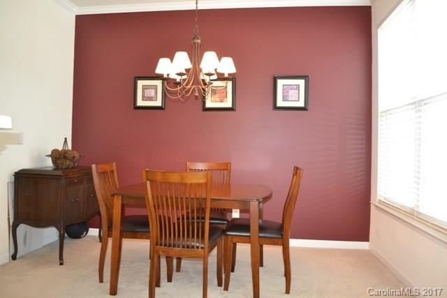 310 Tinder Box Lane, Unit 310 Fort Mill, SC 29708 - Photo 6 of 19 a view of a dining room with furniture and chandelier