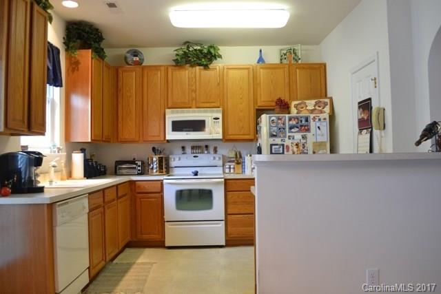 310 Tinder Box Lane, Unit 310 Fort Mill, SC 29708 - Photo 7 of 19 a kitchen with stainless steel appliances a stove a sink a refrigerator and cabinets