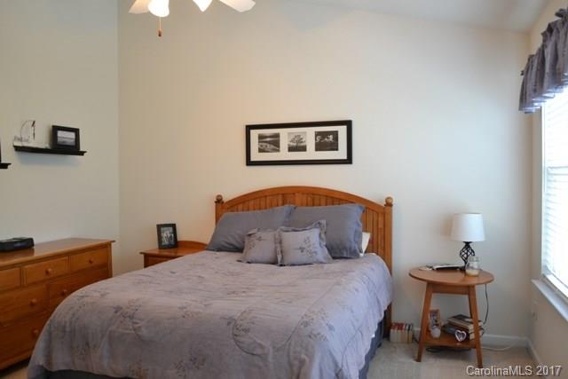 310 Tinder Box Lane, Unit 310 Fort Mill, SC 29708 - Photo 8 of 19 a bedroom with a bed and a lamp on table