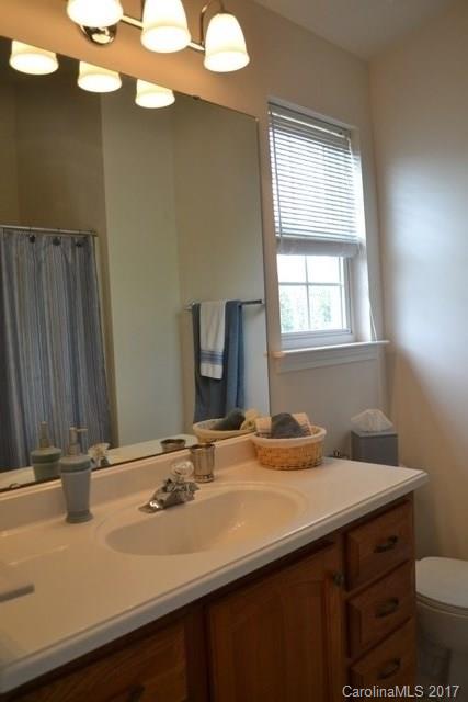 310 Tinder Box Lane, Unit 310 Fort Mill, SC 29708 - Photo 10 of 19 a bathroom with a sink vanity and a mirror