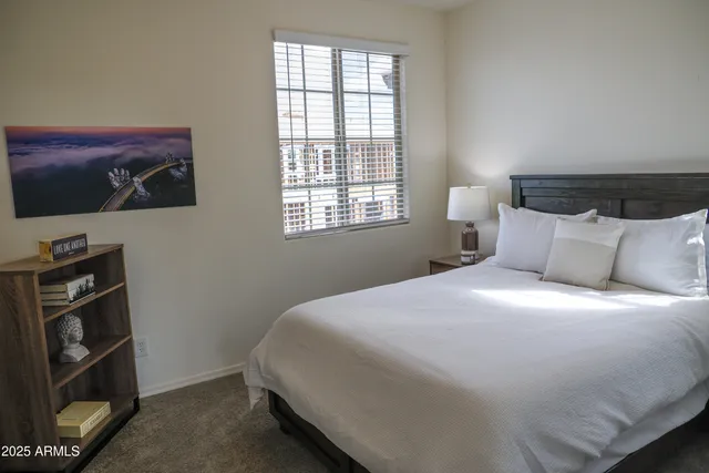 a bedroom with a bed and a window