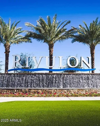 a front view of a house with a garden and a yard