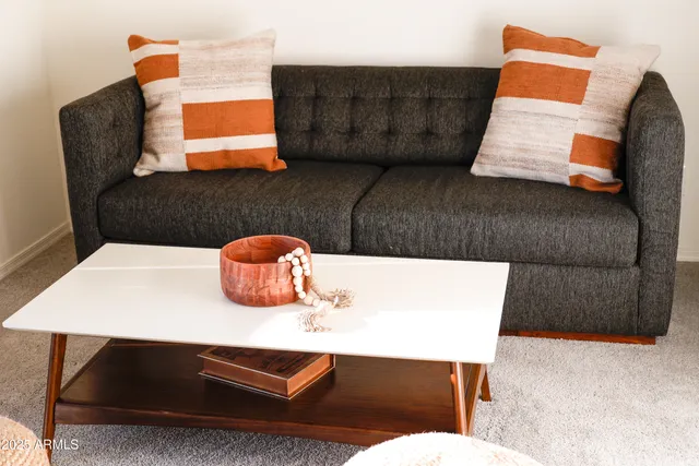 a living room with a couch and a lamp on table
