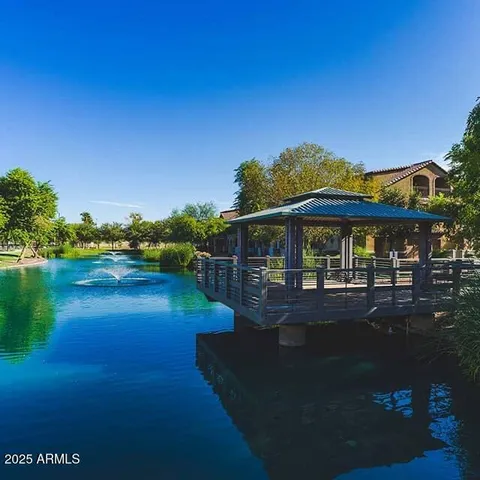 a view of a house with pool and lake view