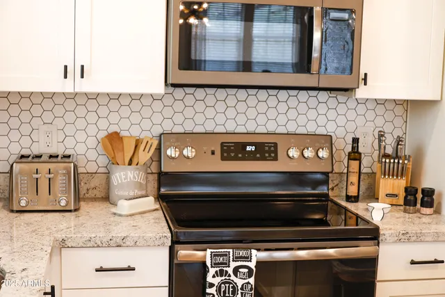 a kitchen with granite countertop a stove and a sink