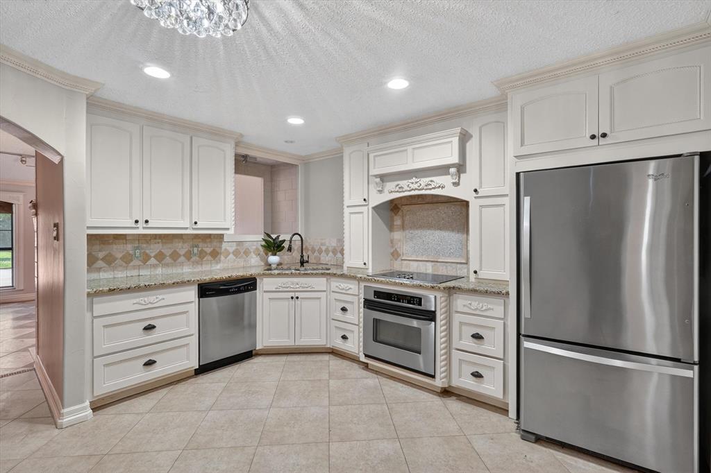 272 Lodge Road Coppell, TX 75019 - Photo 7 of 24 a kitchen with cabinets stainless steel appliances and a counter space