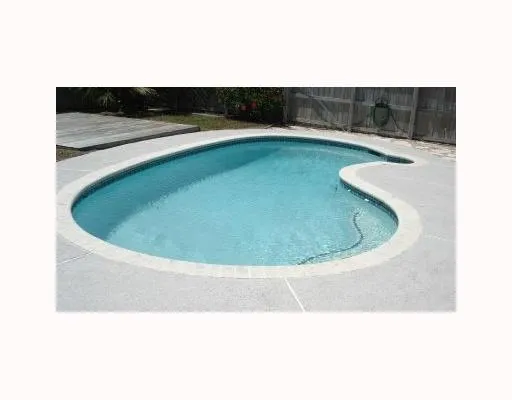 a view of open kitchen with furniture and wooden floor