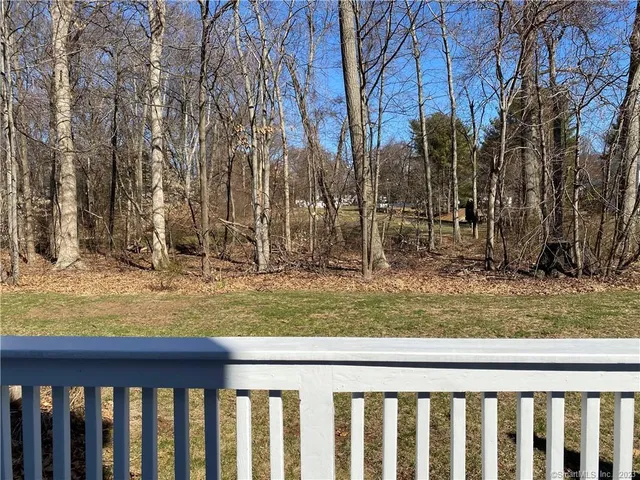 a view of a yard with wooden fence