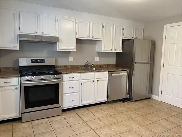a kitchen with cabinets appliances and a sink
