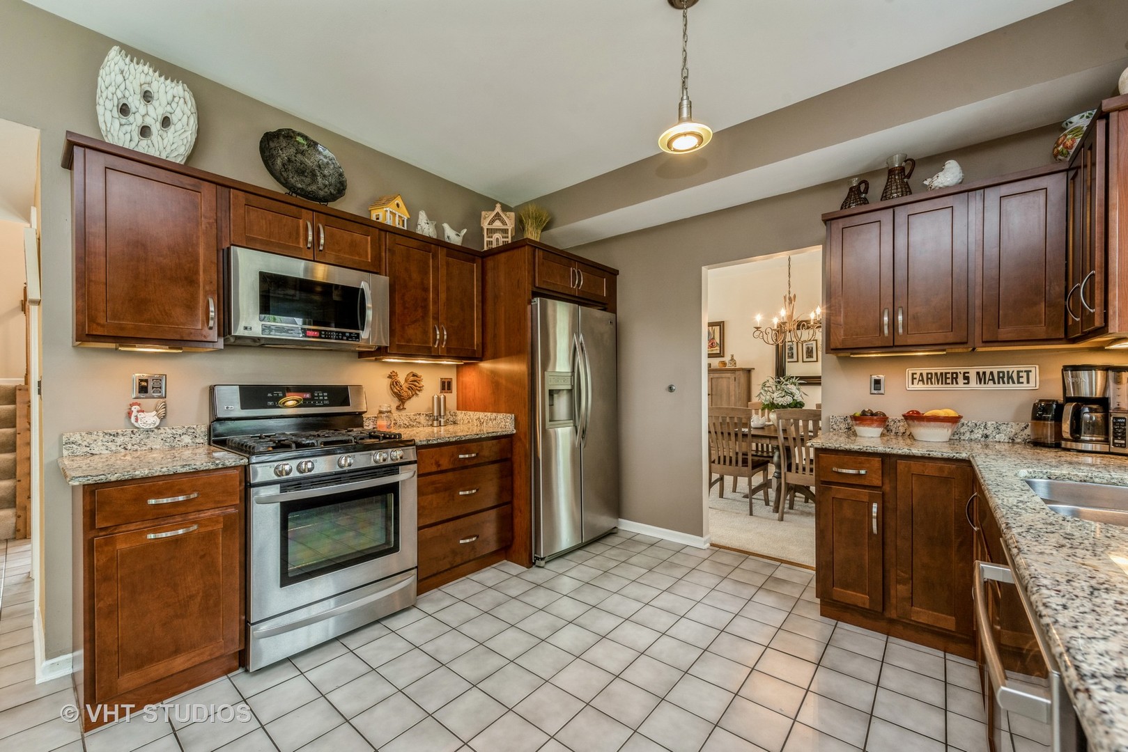 Undisclosed Address Algonquin, IL 60102 - Photo 9 of 40 a kitchen with stainless steel appliances granite countertop a stove top oven a sink dishwasher a dining table and chairs with wooden cabinets