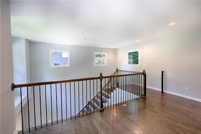 a view of hallway with wooden floor