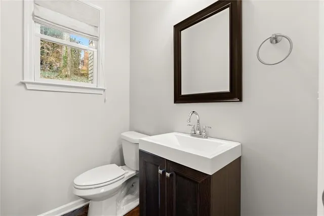 a bathroom with a toilet sink and mirror